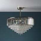 A close-up shot of a magnificent crystal chandelier against a dark blue background.