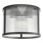 A close up view of a ceiling mounted cylindrical light with fluted glass and a black frame.