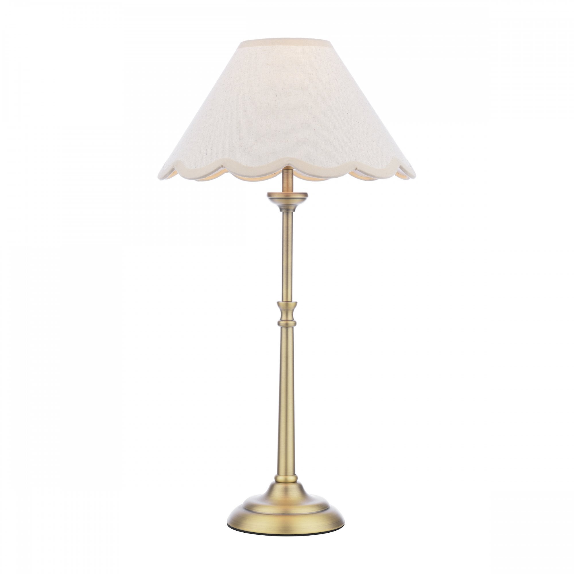 A brass table lamp with a cream scalloped shade on a white background.