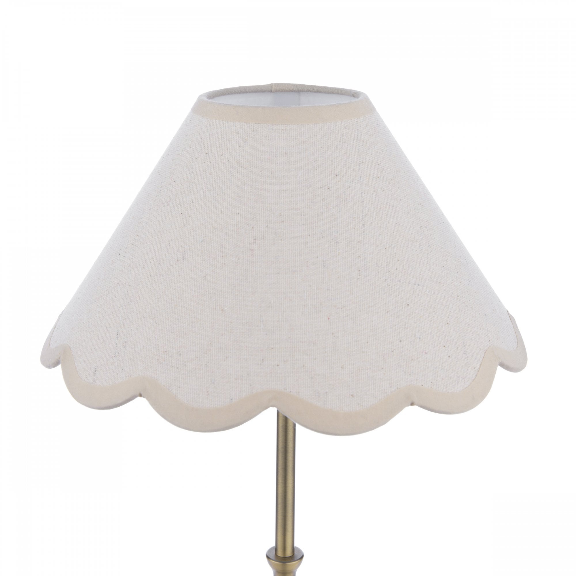 Close-up of a cream scalloped lampshade with a subtle texture.