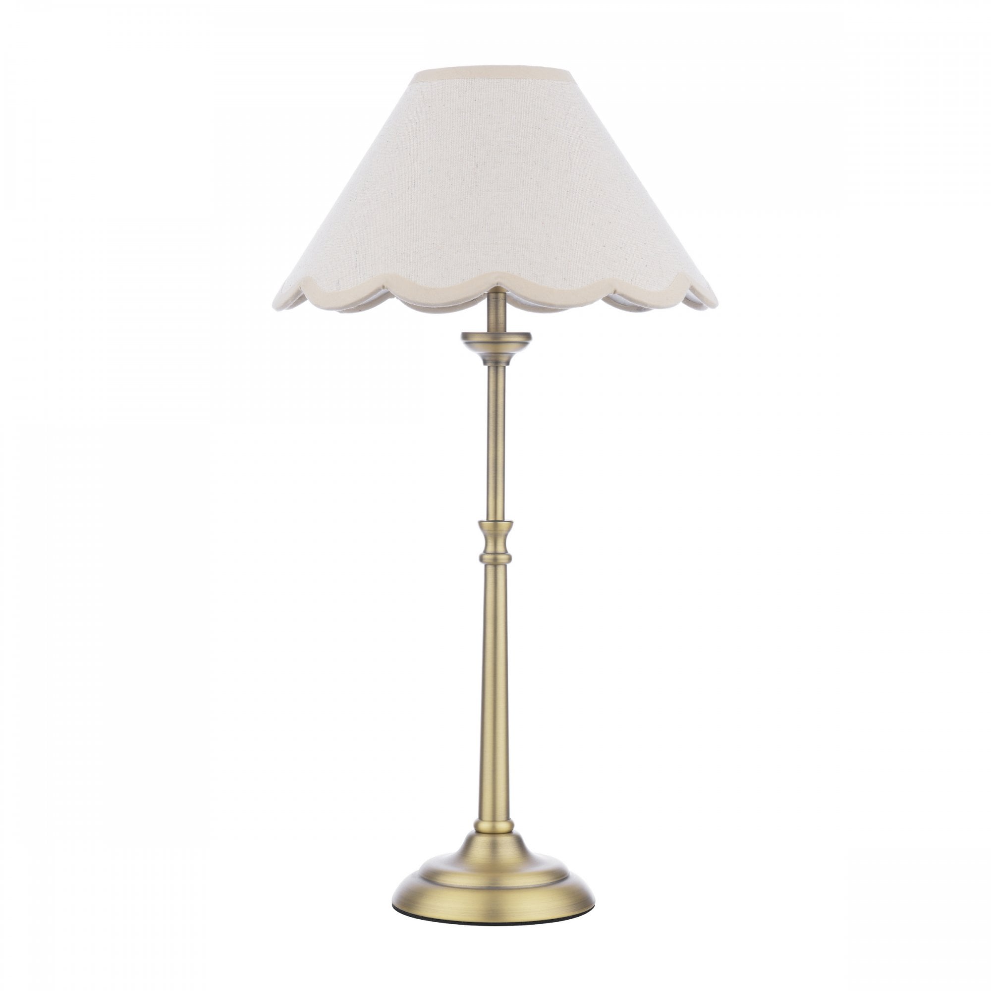 A brass table lamp with a cream scalloped shade on a white background.