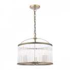 An antique brass and clear reeded glass pendant light, isolated on a white background.