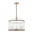 An antique brass and clear reeded glass pendant light, against a plain white background.