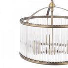 A close-up of the antique brass and reeded glass shade of the pendant light fixture.