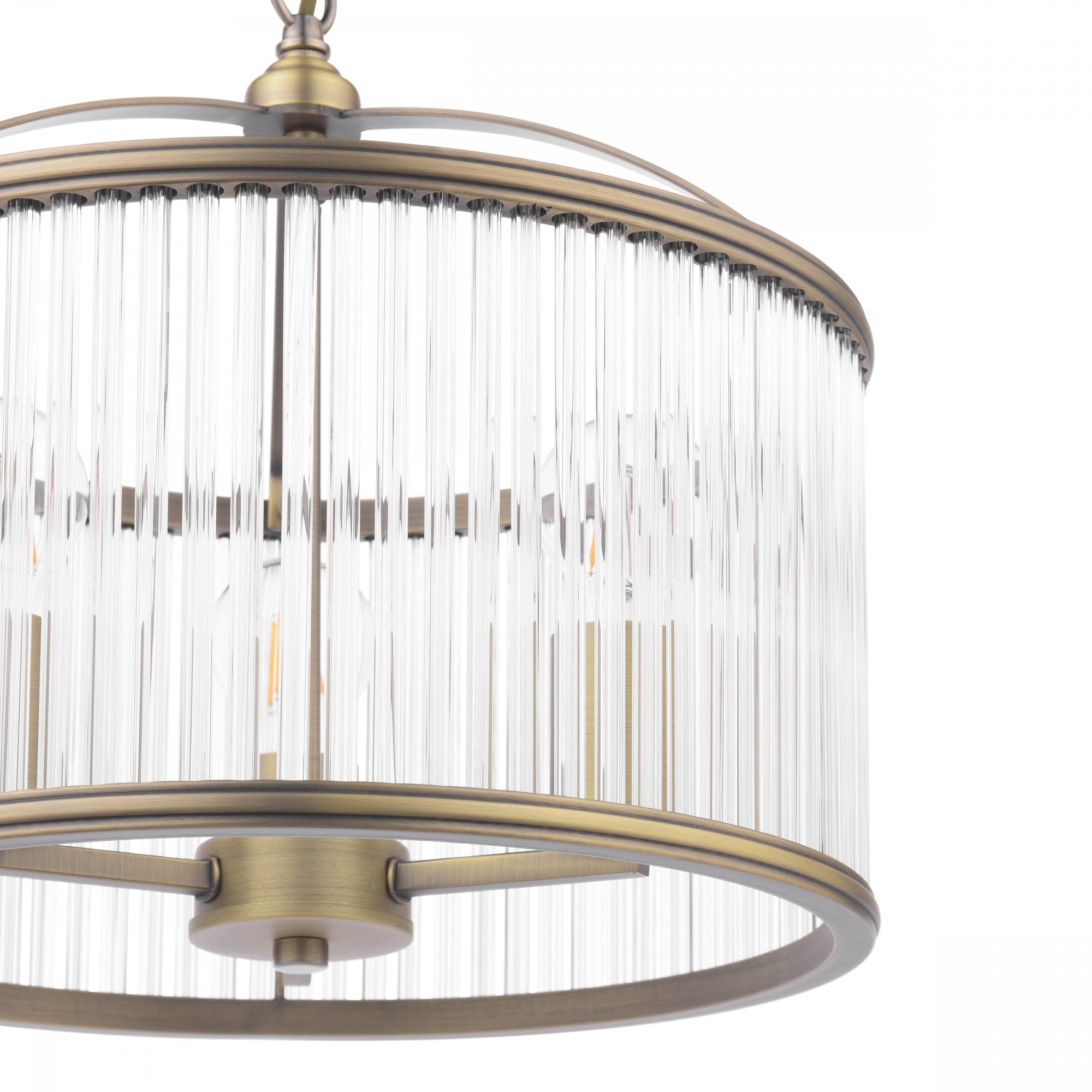 A detailed view of the clear reeded glass and brass frame of the pendant light.