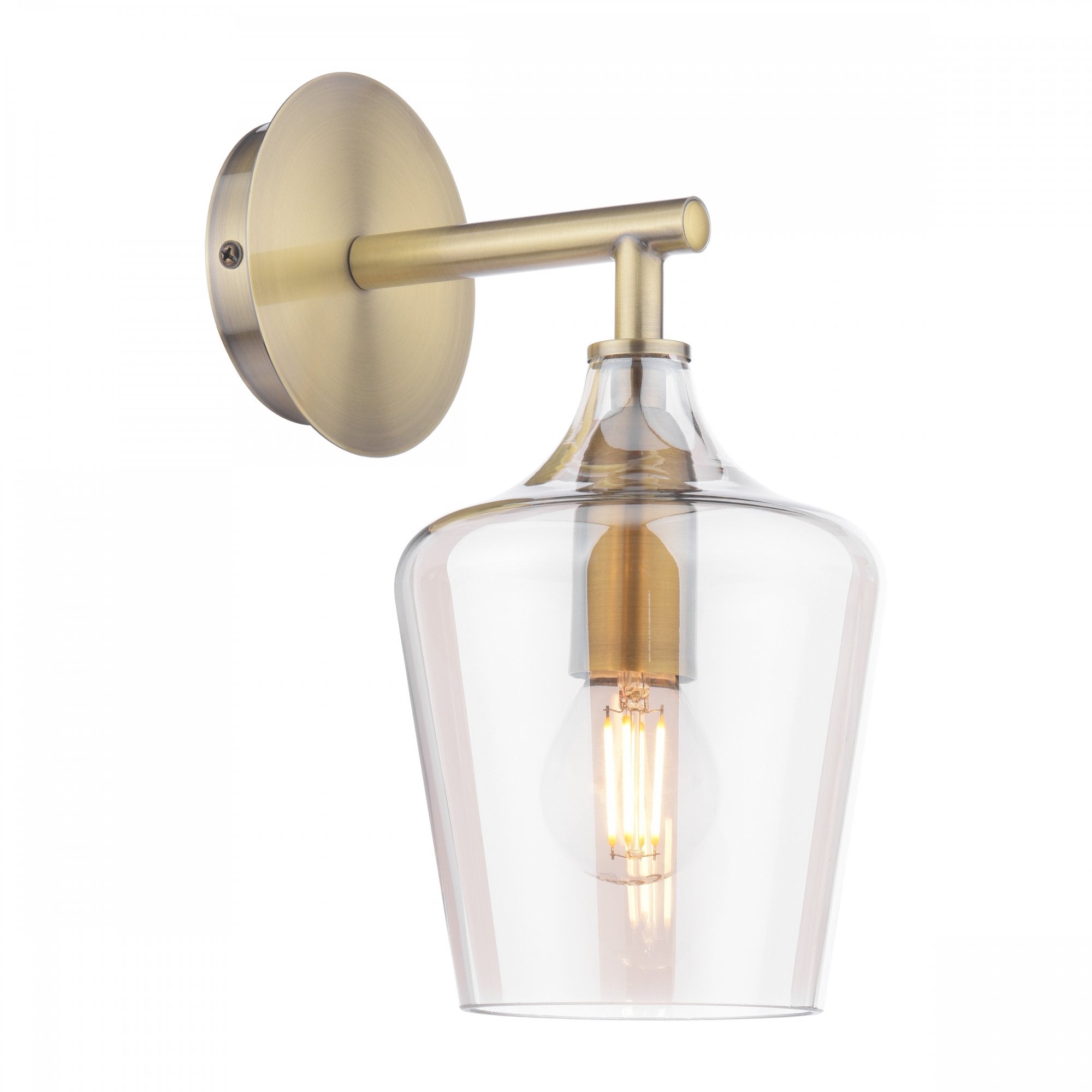 A brass wall light with a clear glass shade and an Edison bulb on a white background.