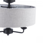 Close-up of a semi-flush mount ceiling light with a grey fabric drum shade and black fixtures.