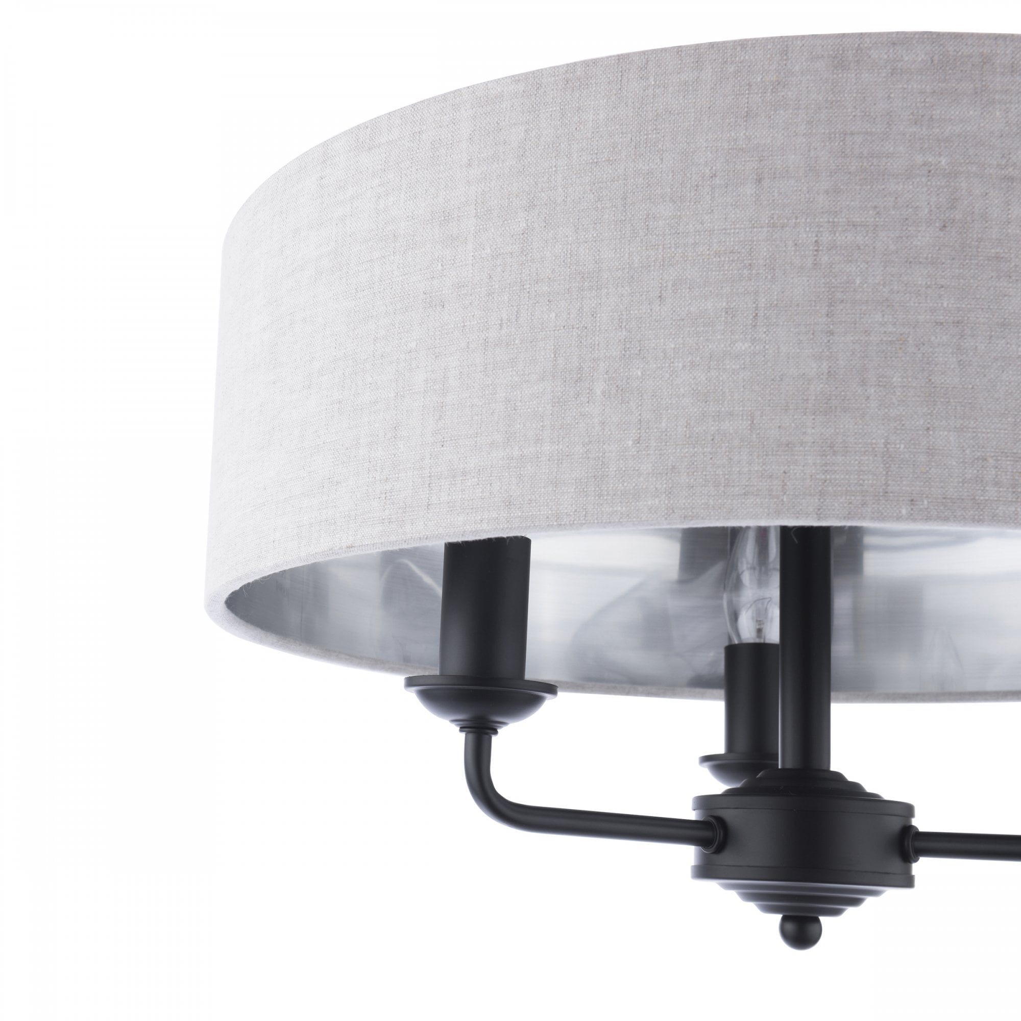 Close-up of a semi-flush mount ceiling light with a grey fabric drum shade and black fixtures.