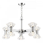 A modern chrome chandelier with six crystal shades, casting a bright glow.