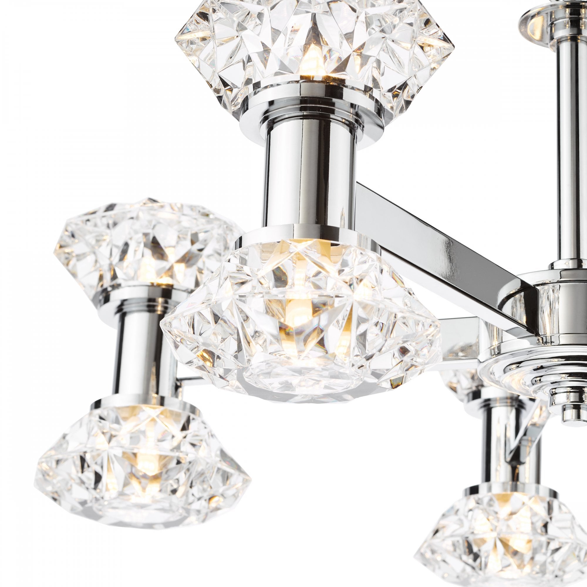 Detailed view of the illuminated crystal shades on a polished chrome chandelier.