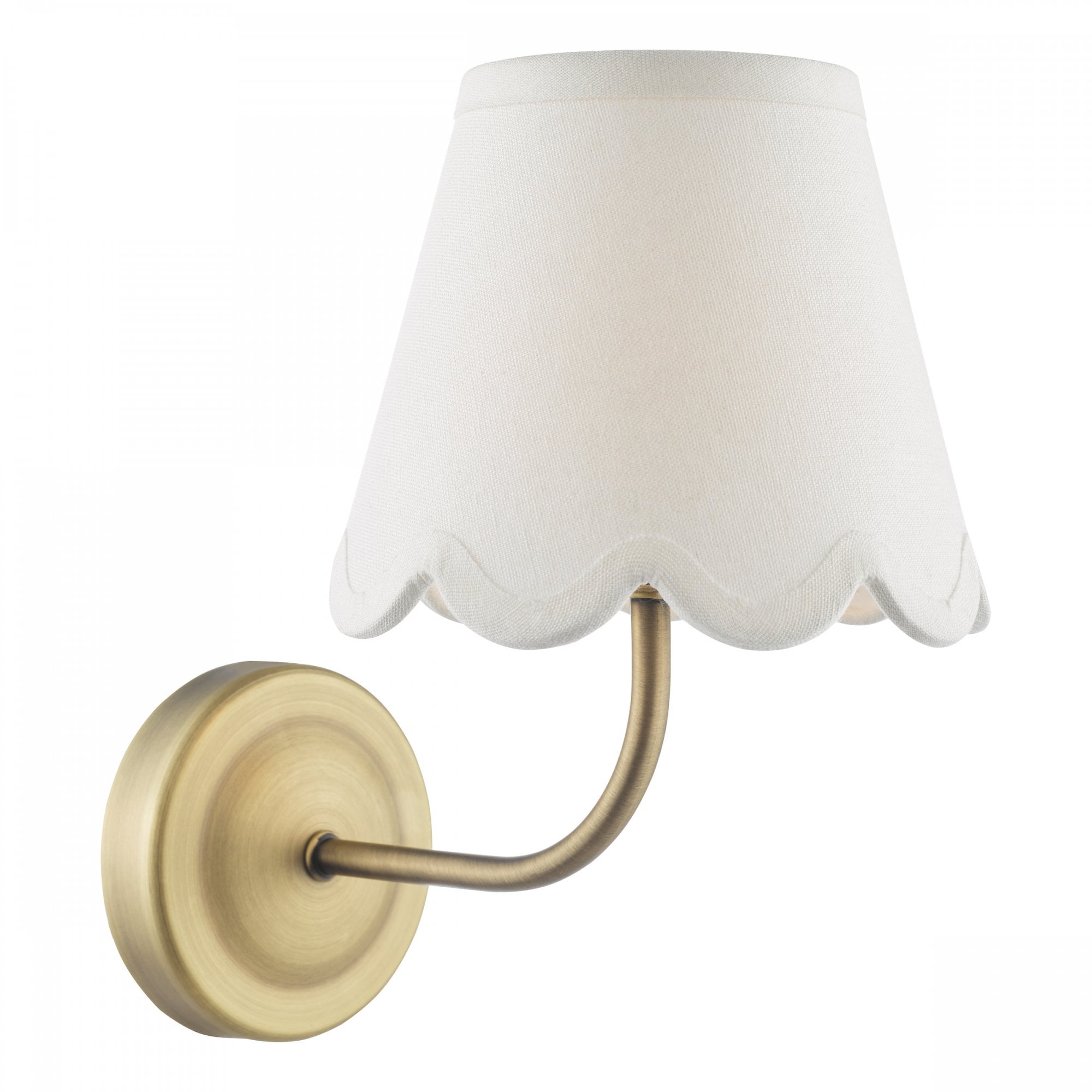 Brass wall sconce with a white scalloped fabric shade, isolated on white.