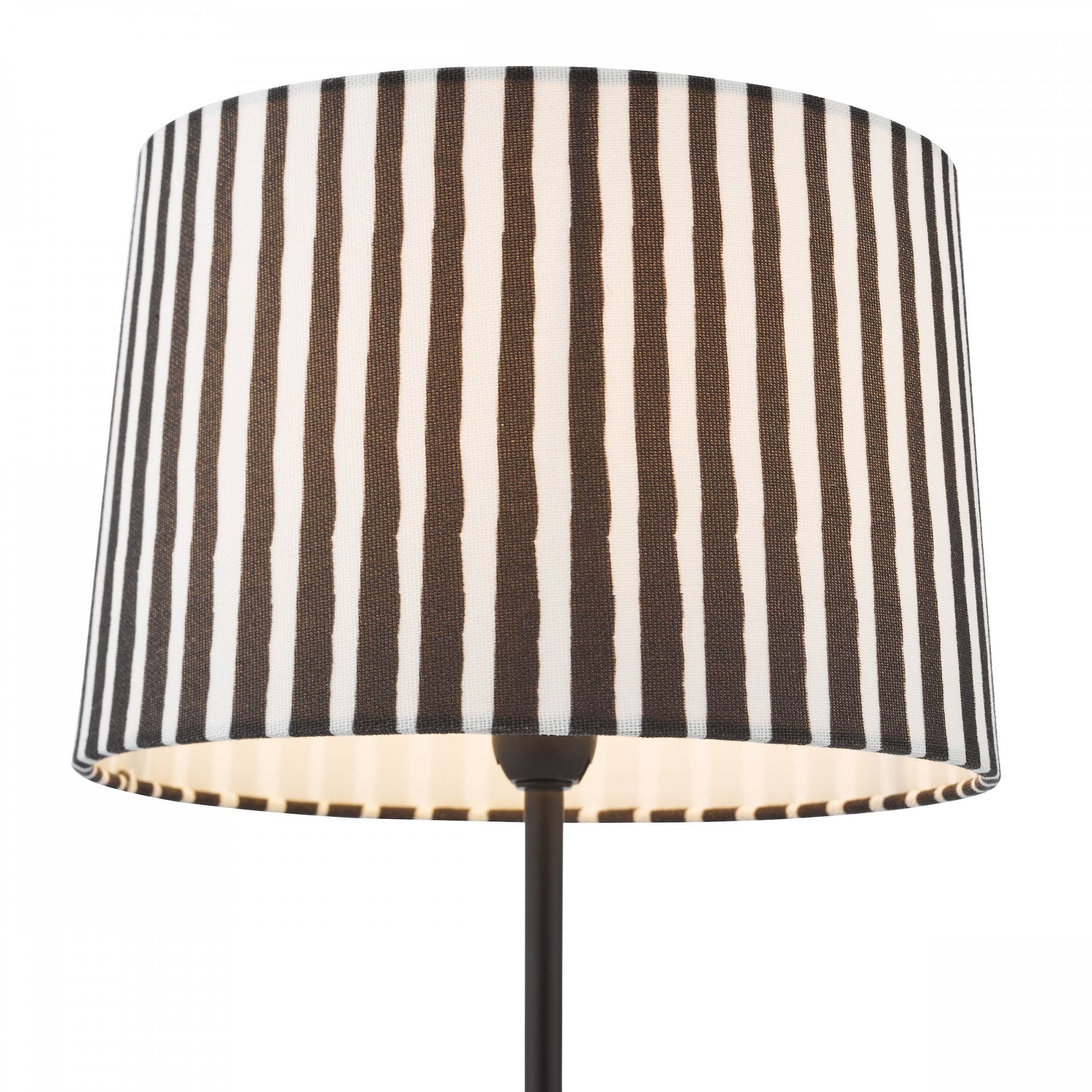 A close up of a striped black and white lamp shade with a black lamp stand.