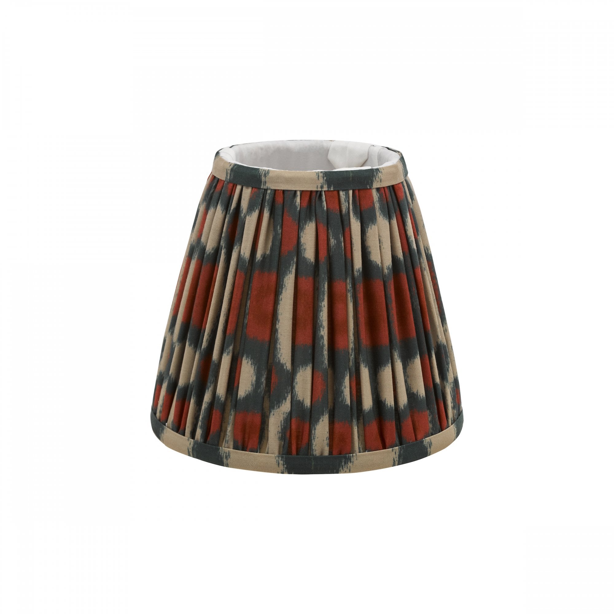 Pleated ikat lampshade in rust and gray with a neutral trim.
