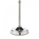 The polished nickel base of a table lamp with a dimmer switch.