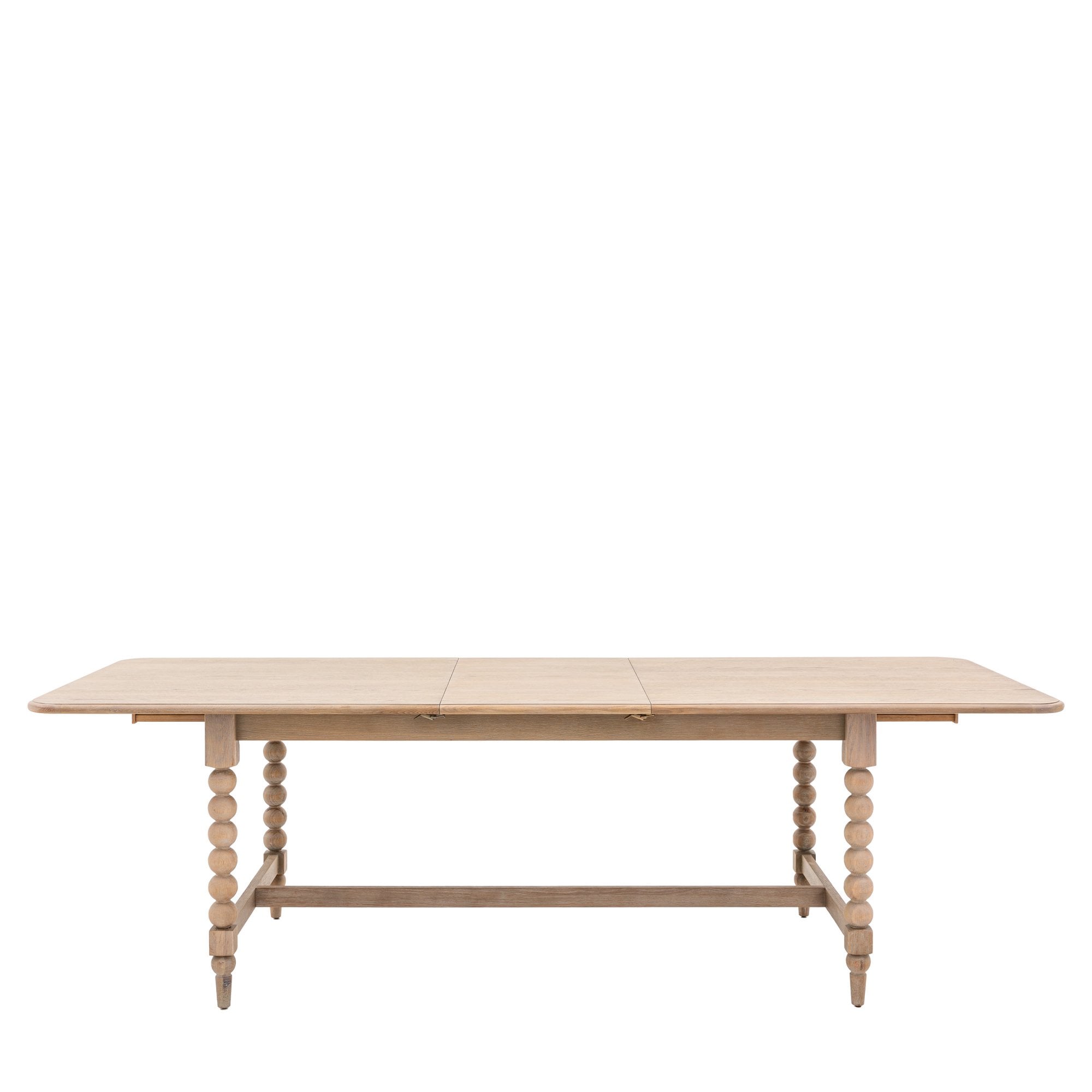 A light wood dining table with bobbin legs on a white background, viewed from the front.