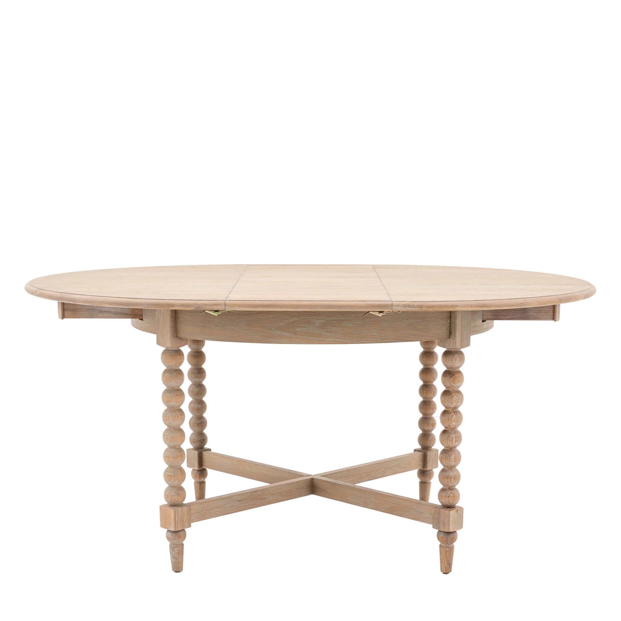An oval light wood dining table with two leaves extended.