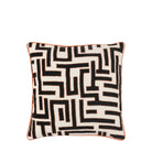 A black and white throw pillow with a geometric pattern and orange piping on a white background.