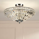 A close-up of a glamorous crystal ceiling light, featuring multiple facets that reflect light.