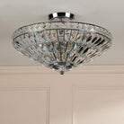 A sparkling crystal ceiling light on a white ceiling, providing a touch of elegance.