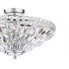 A partial view of a luxurious crystal ceiling light, highlighting its reflective qualities.