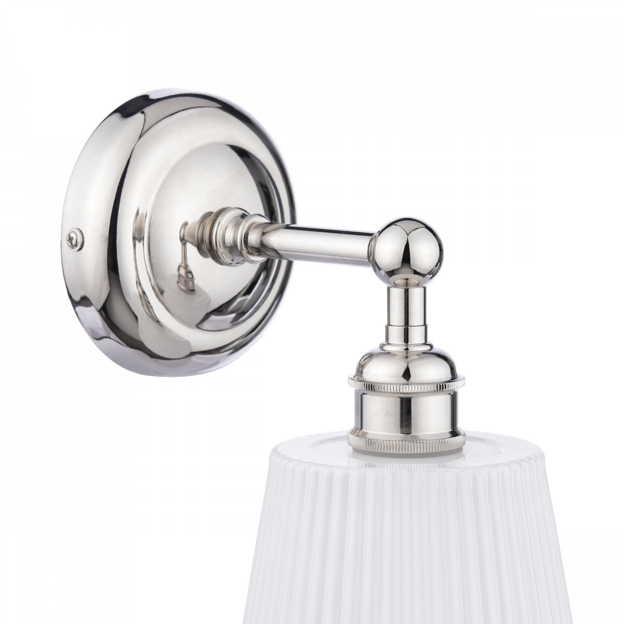 Close-up of a polished nickel wall light with a white pleated shade.