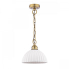 A white ribbed ceramic dome pendant light with a brass chain on a white background.