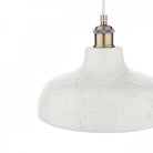 Close-up of the white textured shade and brass fixture of a pendant light.