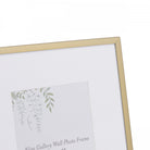 Close-up of a gold picture frame with a white mat and a floral design insert.