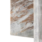 Detail of the marble table's surface, highlighting its natural brown and white patterns.