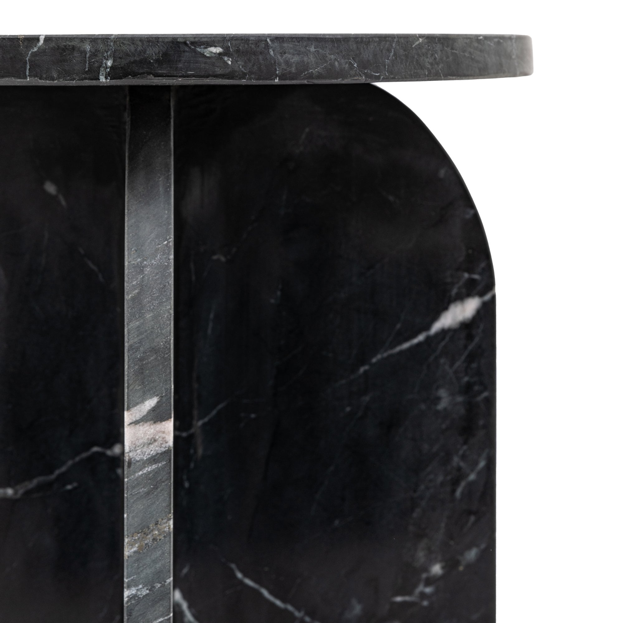 Detailed view of the black marble side table's top and arched leg.