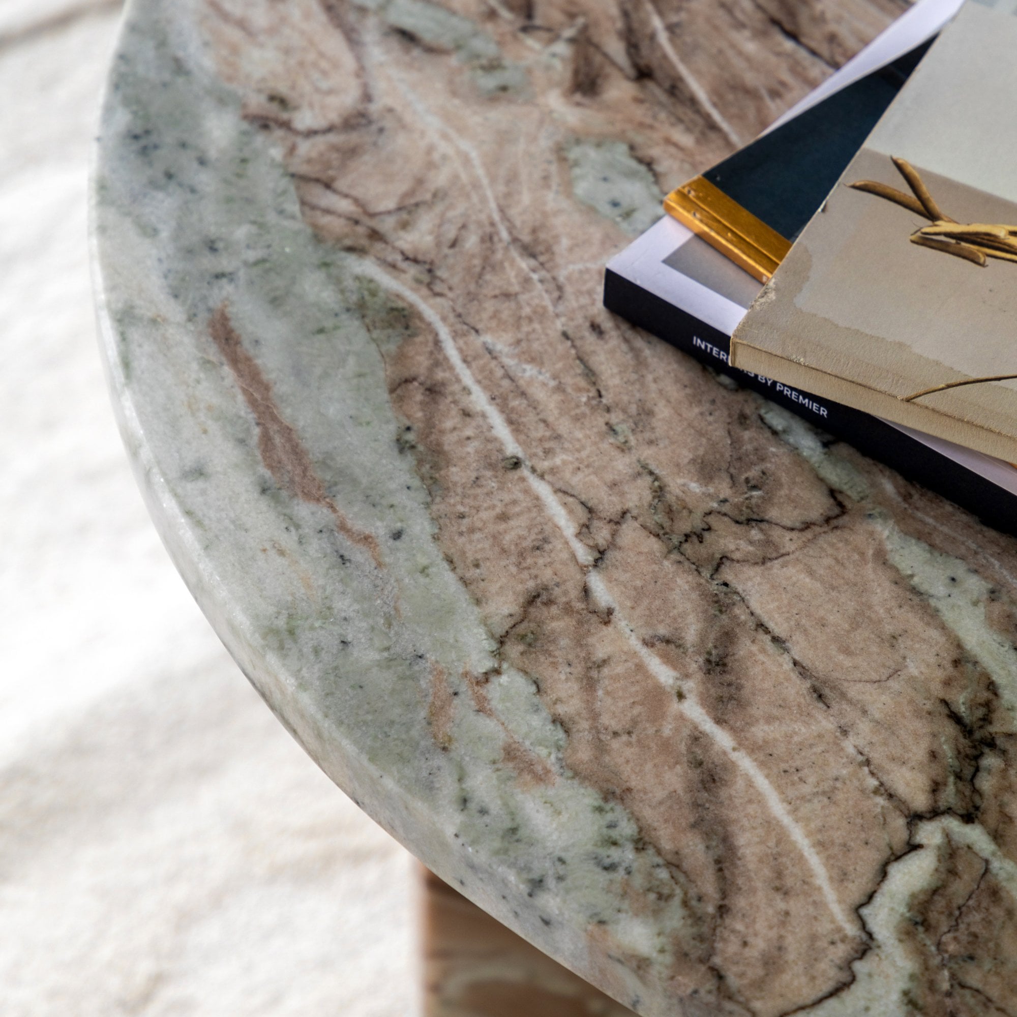 Close-up of the marble tabletop with magazines, showing the intricate veining.