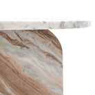 Close-up of the rounded edge of the marble table top and its base.