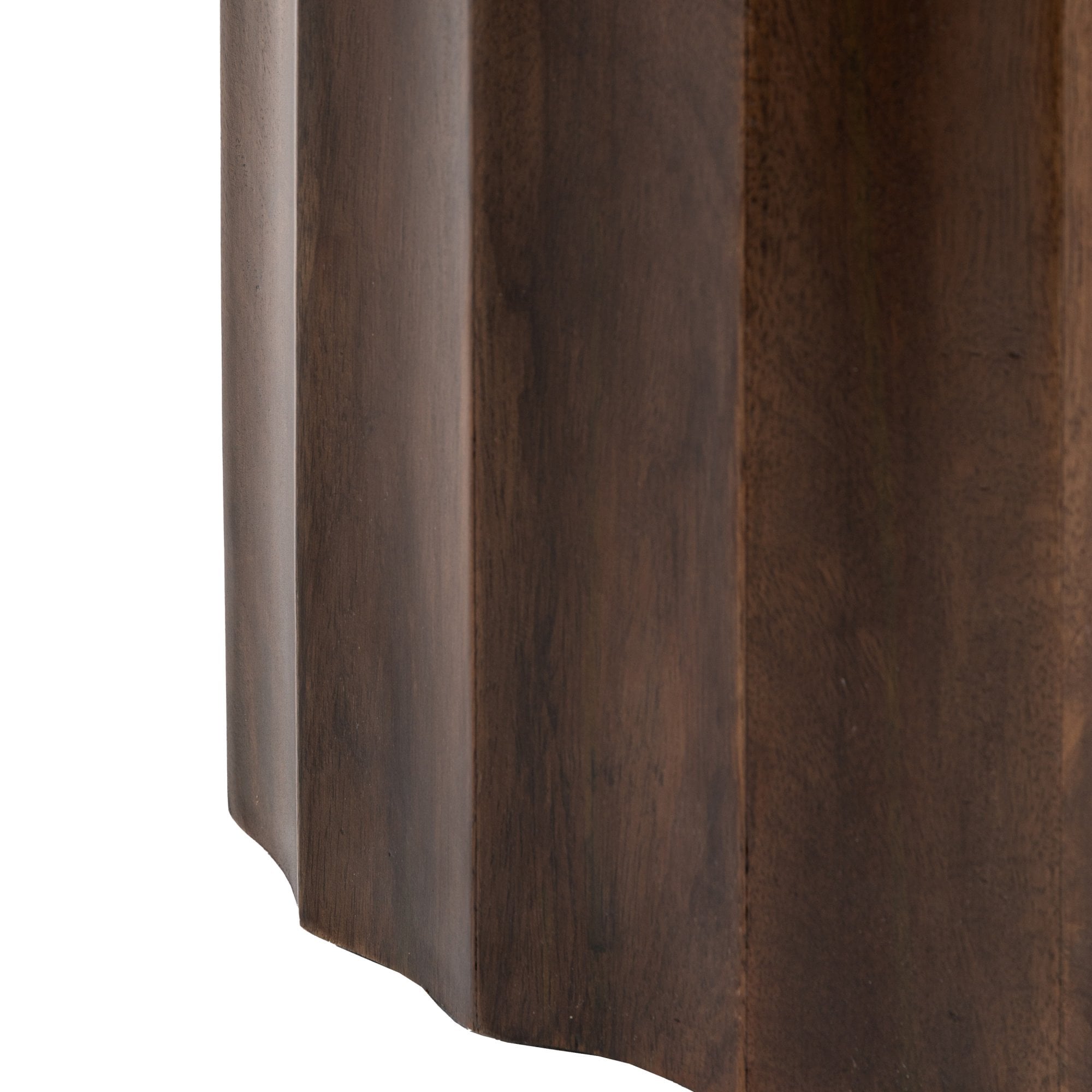 A detailed shot of the fluted texture and grain of the dark wood side table.