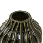 The top opening of a dark green fluted vase.