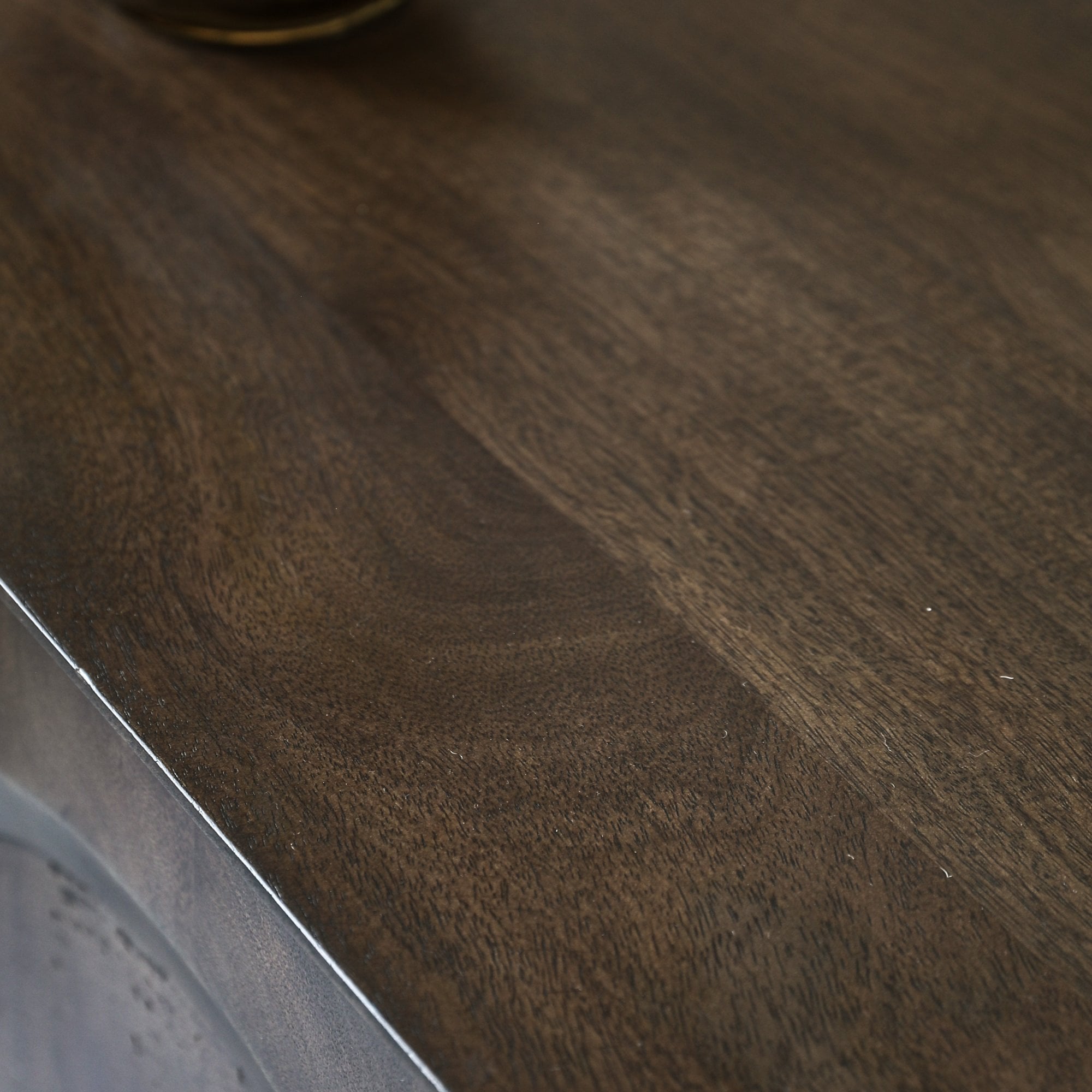 Close-up of the dark brown wooden texture of the cabinet top.