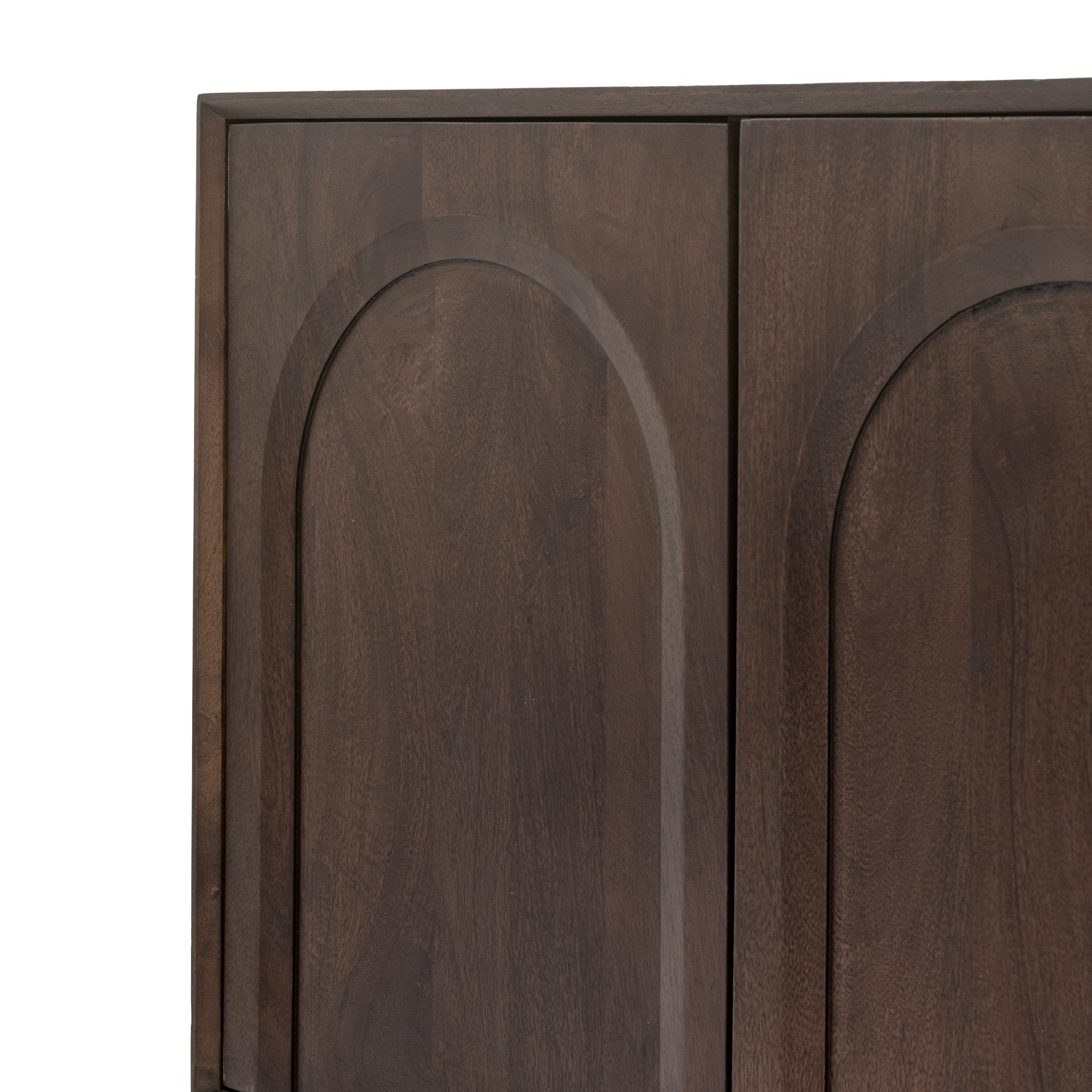 Close-up of two dark brown cabinet doors with arched paneling.