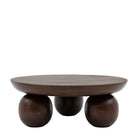 Front view of a dark wood round coffee table with three large spherical legs.