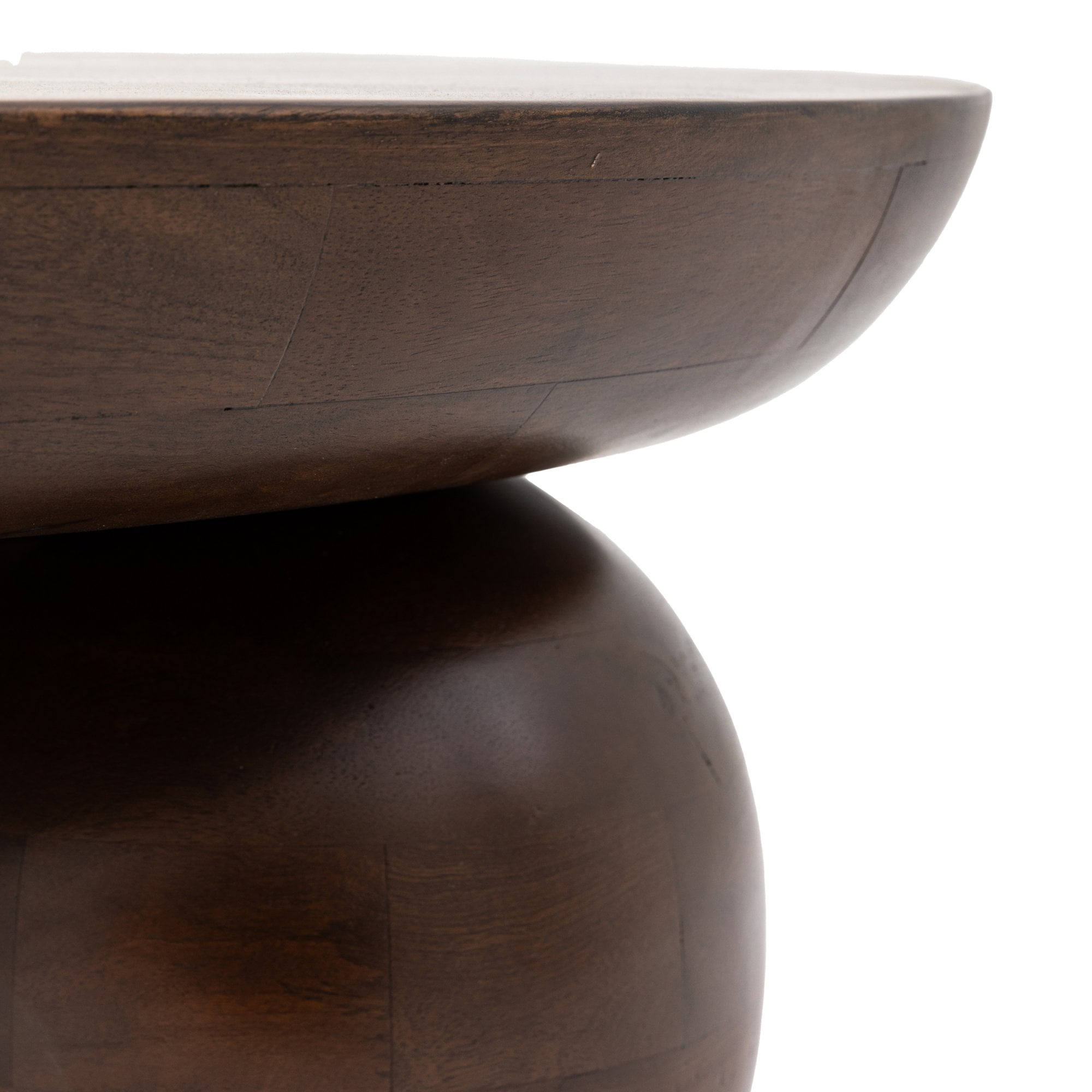 Close-up of the smooth dark wood coffee table and its spherical leg design.