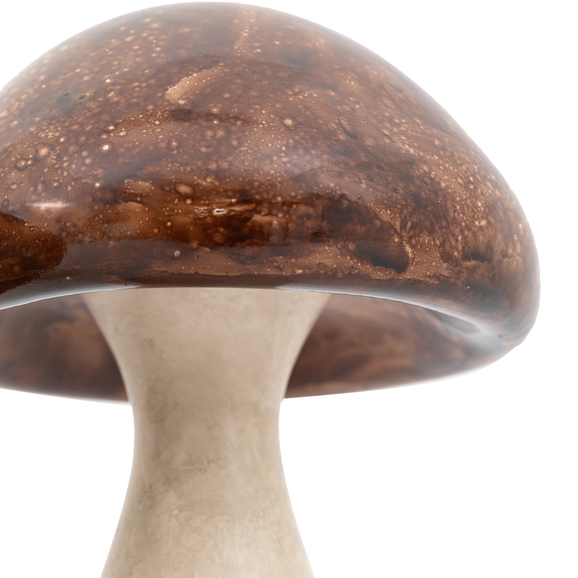 Close-up of the glossy brown cap and cream stem of a decorative mushroom ornament.