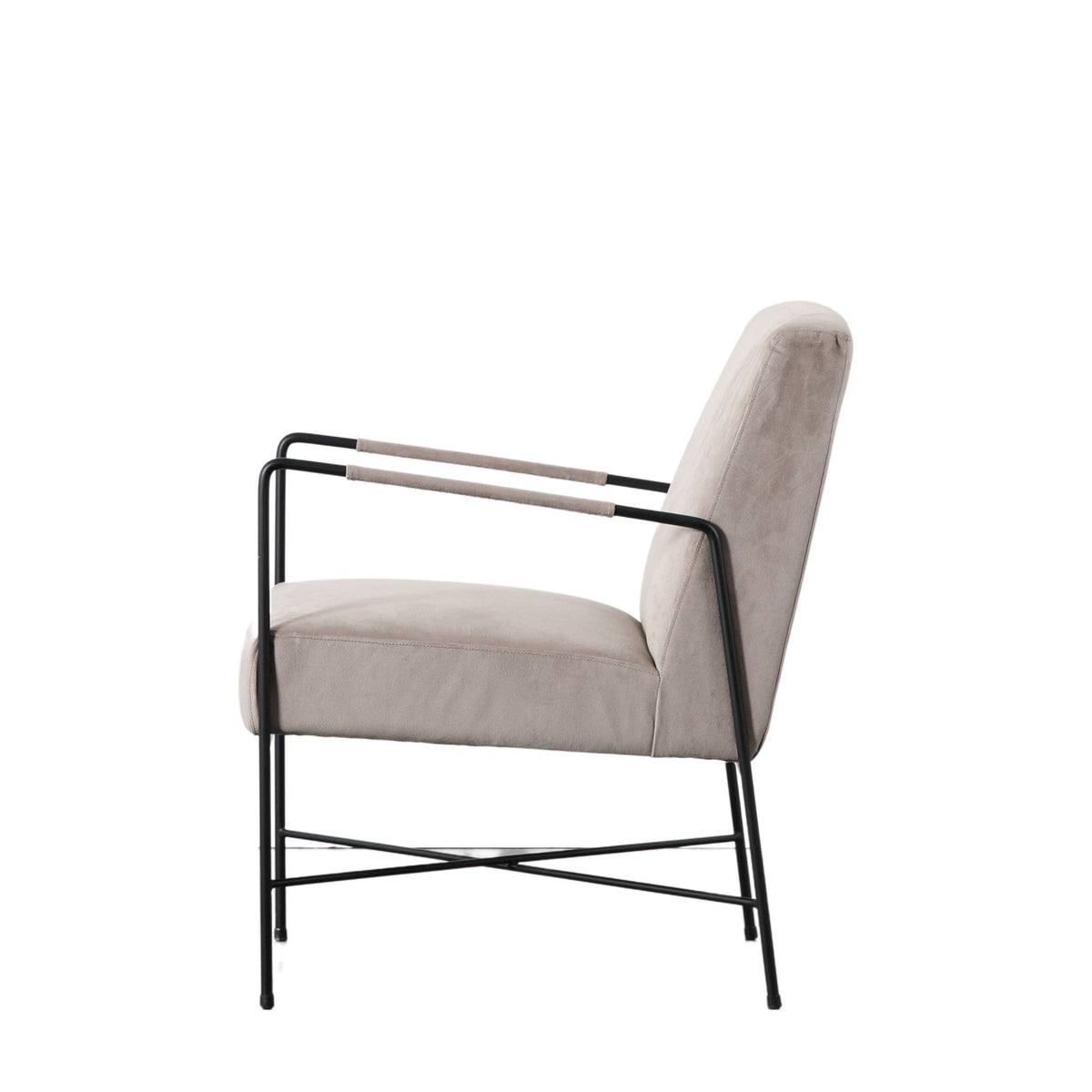 Side view of a beige armchair with a black metal frame and light arm wraps.