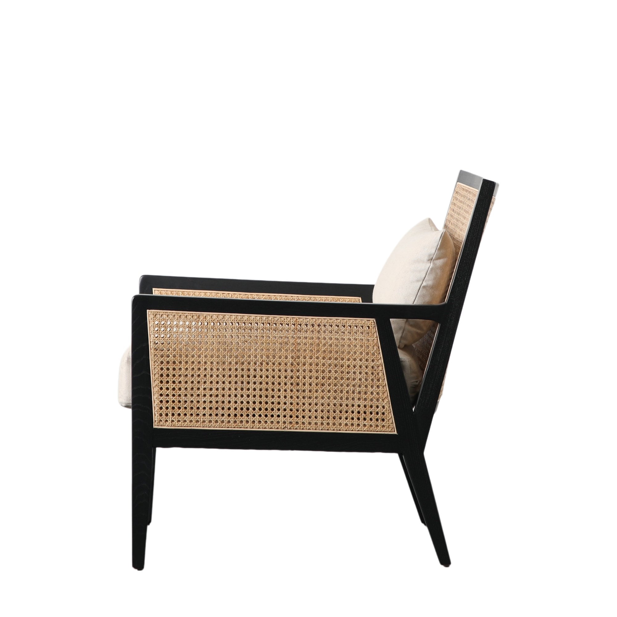 Side profile of the black wooden armchair featuring cane panels and a light cushion.