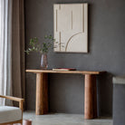 Mango wood console table with a minimalist design, a decorative vase, and abstract art.