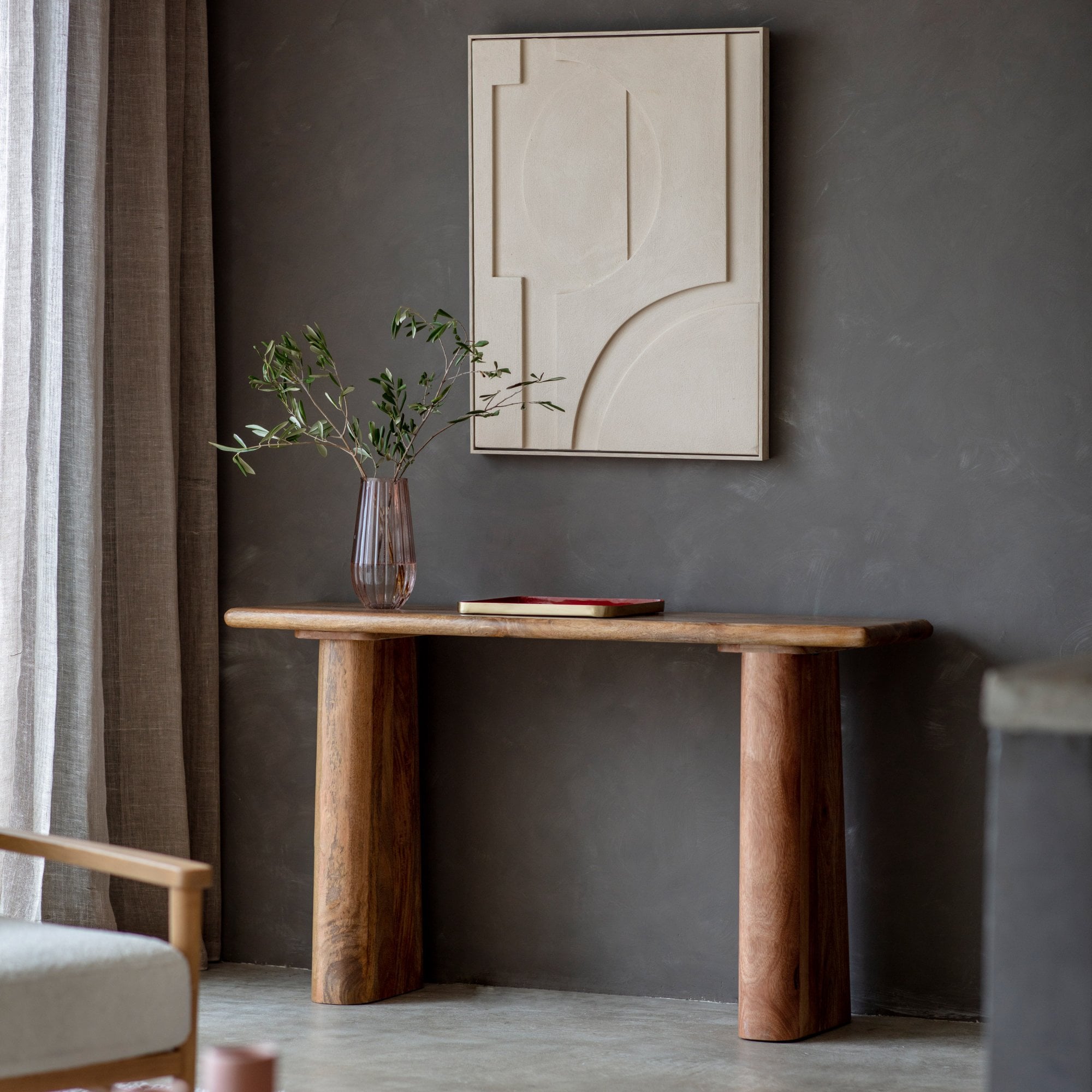 Mango wood console table with a minimalist design, a decorative vase, and abstract art.
