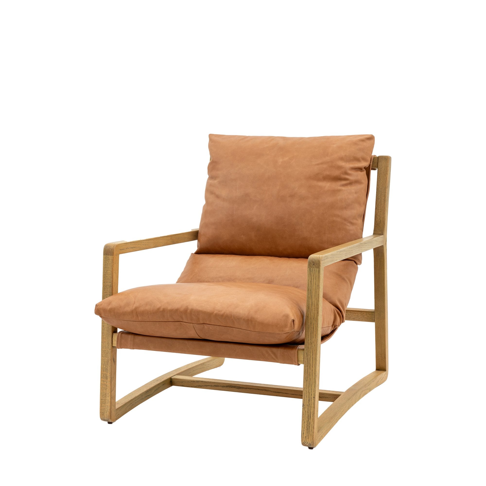 Angled view of a tan leather and light wood armchair.