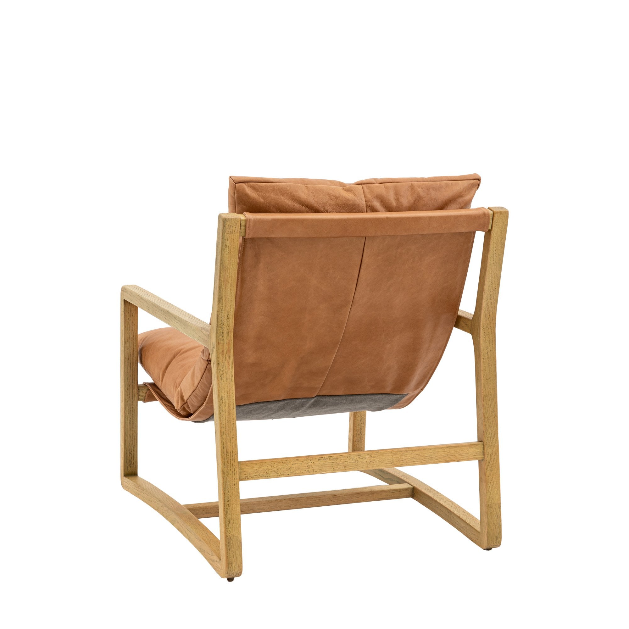 Back view of a tan leather and light wood armchair.