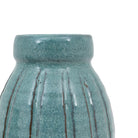 Close-up of the top of a blue ceramic vase, highlighting its textured design.