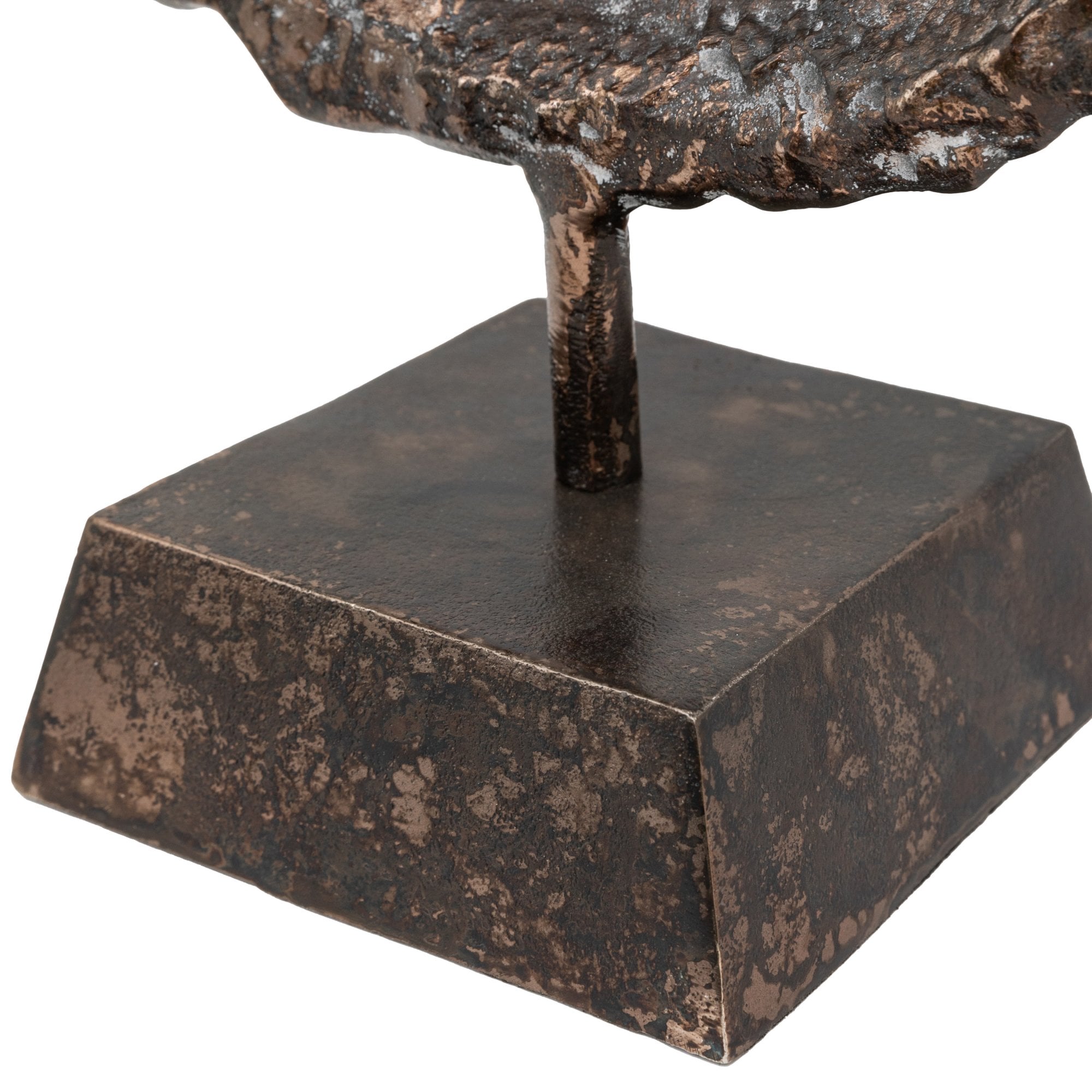 Close-up of the square base of the rustic, bronze-colored metal ring sculpture.