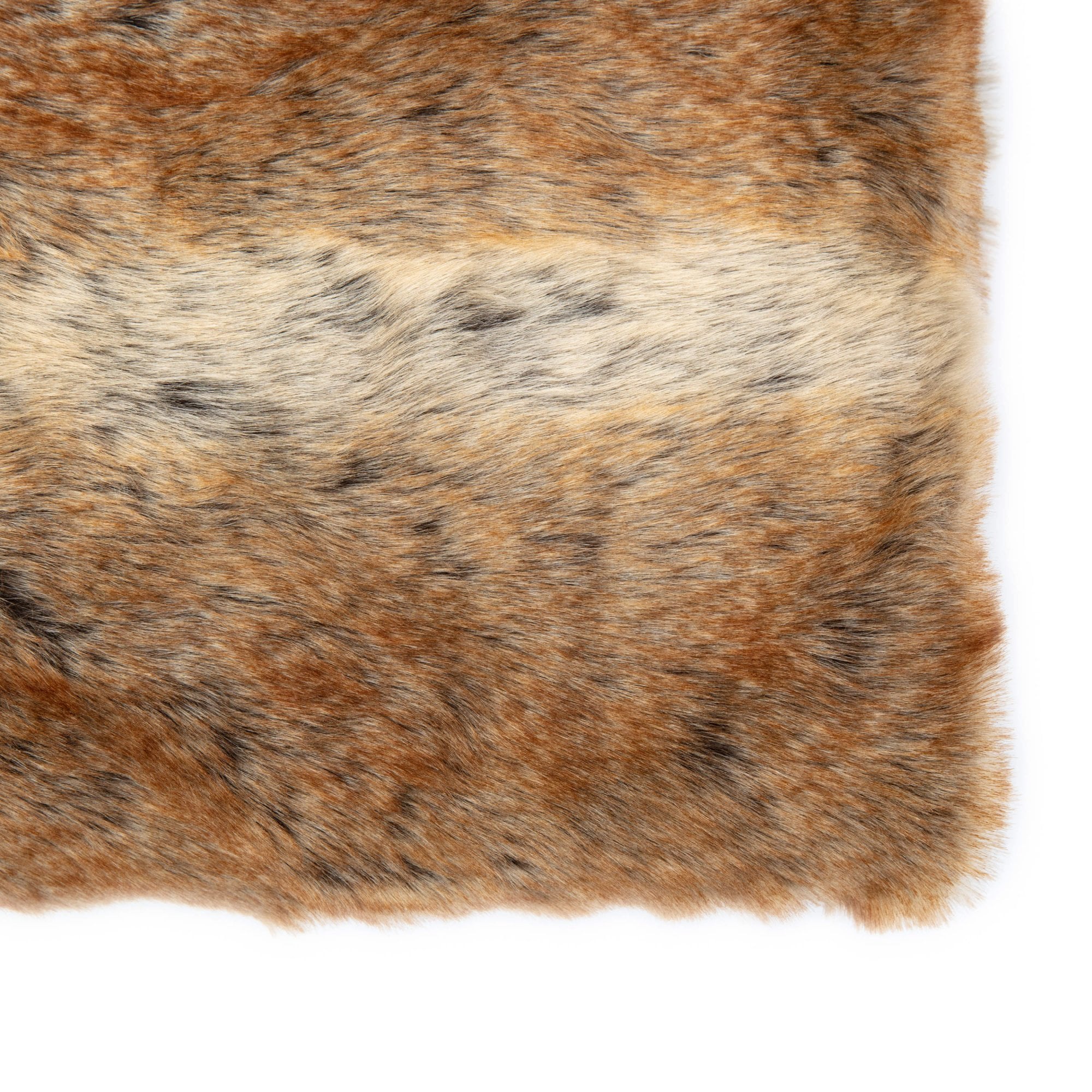 A detailed close-up of the faux fur throw's corner, showcasing its intricate brown, black, and cream pattern.