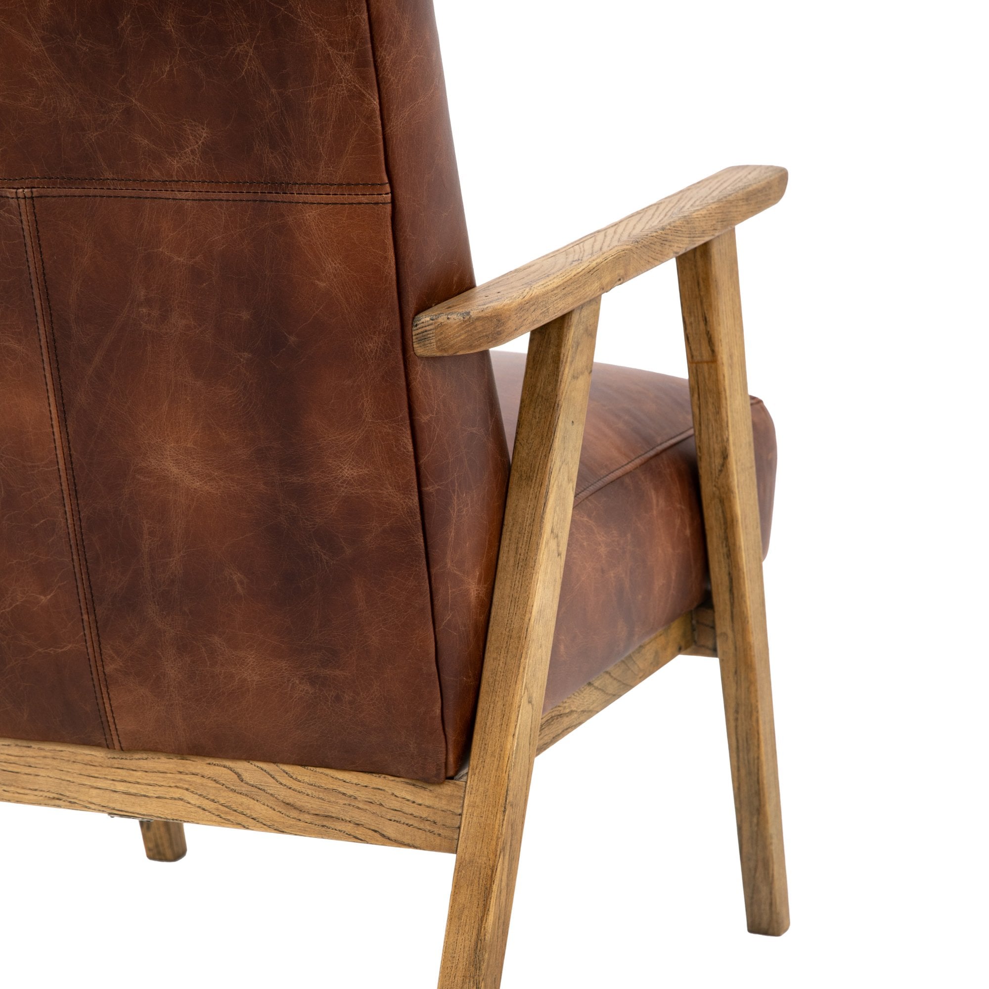 Close-up of the back and armrest of the brown leather armchair with its wooden frame.