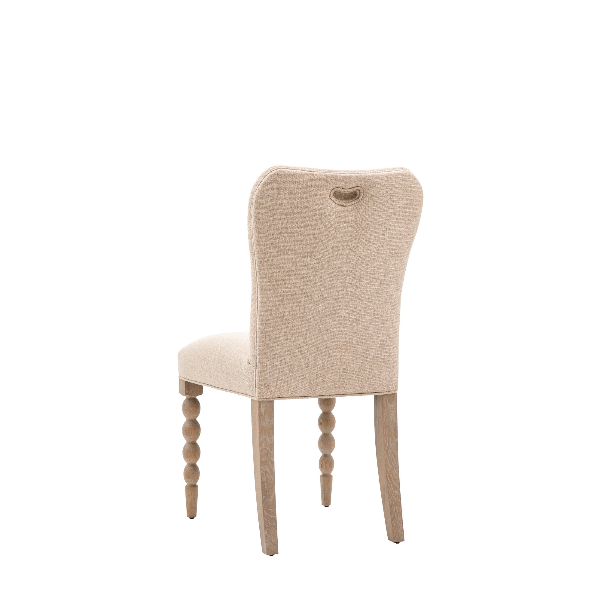 Back view of an upholstered dining chair with a small handle on the backrest.